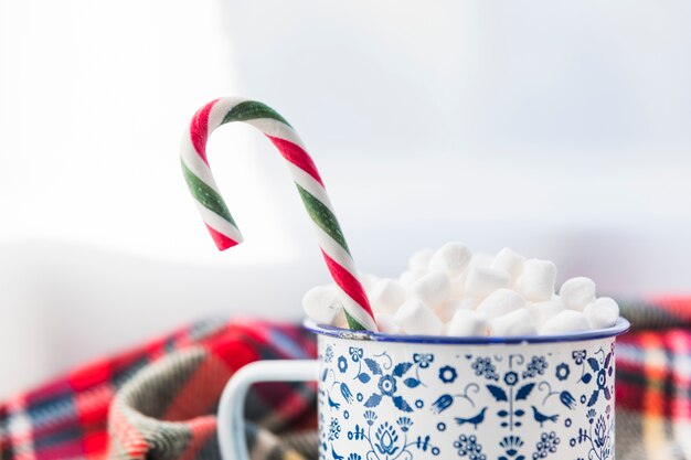 Cup with marshmallow and candy cane 