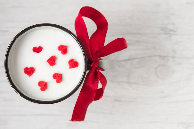 Cup with milk and hearts