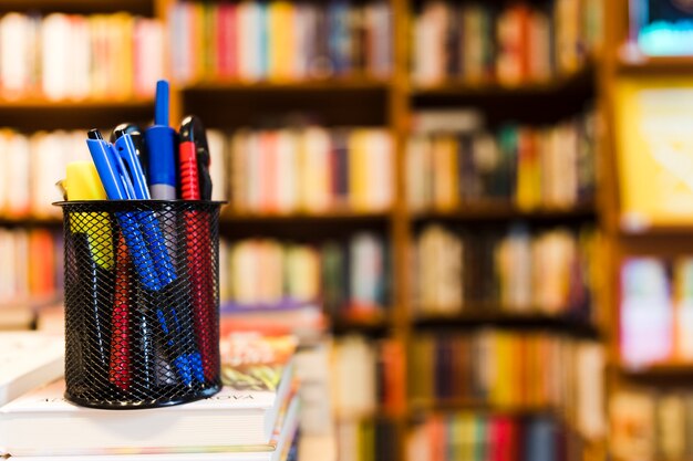 Cup with stationery in library 