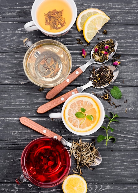 Cup with tea and herbs beside