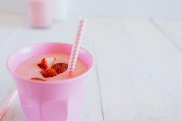 Cup with yummy strawberry smoothie