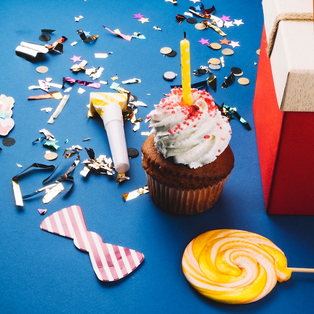 Cupcake with candle and confetti