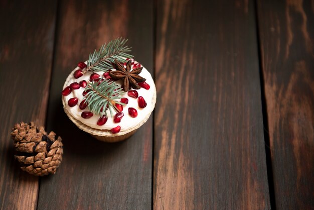 Cupcake with pomegranate and pine cone