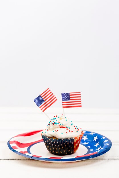 Cupcake with sprinkles and paper flags