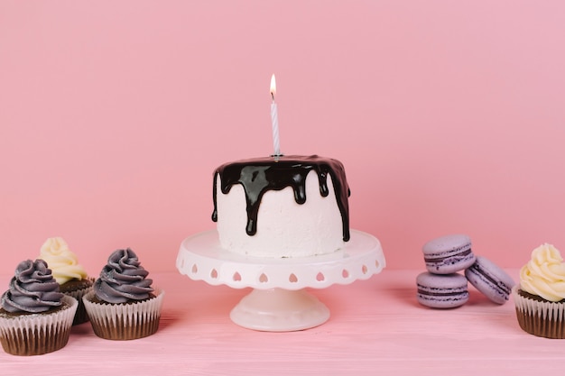 Cupcakes and macaroons near cake