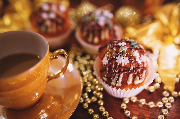 Cupcakes with christmas decoration and a cup
