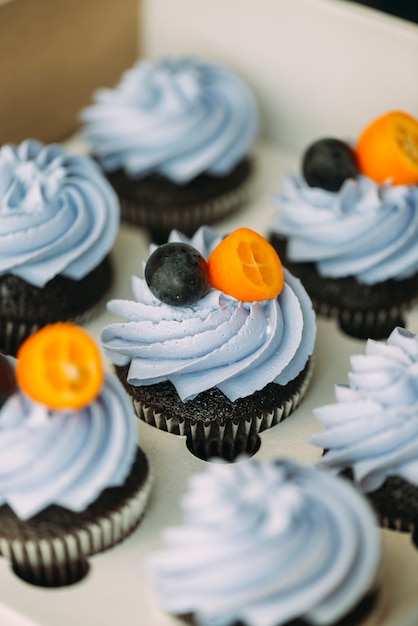 Cupcakes with cream and fruits