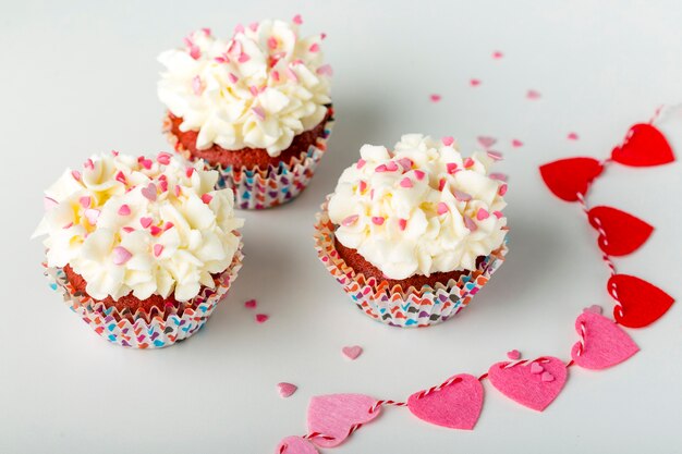 Cupcakes with heart-shaped sprinkles and frosting