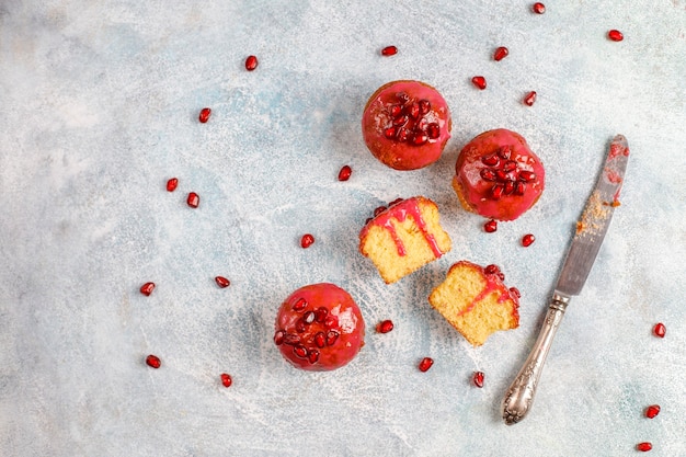 Cupcakes with pomegranate topping and seeds.