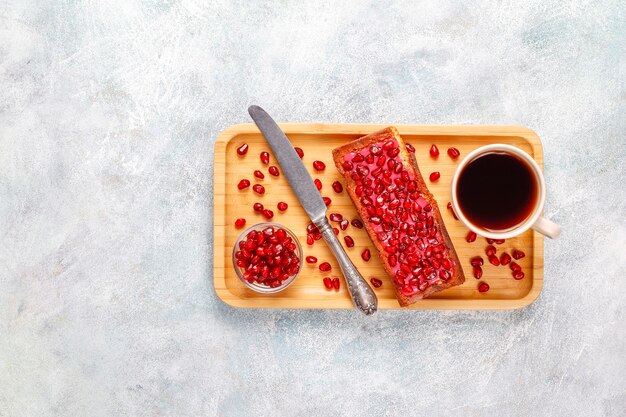 Cupcakes with pomegranate topping and seeds.