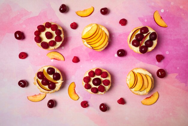 Cupcakes with vanilla cream and summer fruits on the top