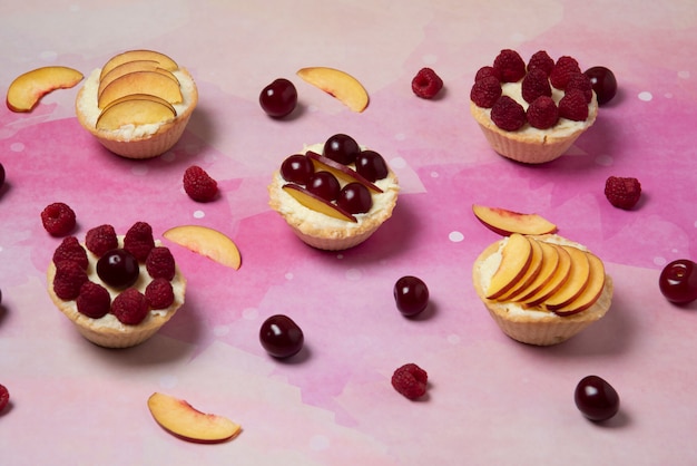 Cupcakes with vanilla cream and summer fruits on the top