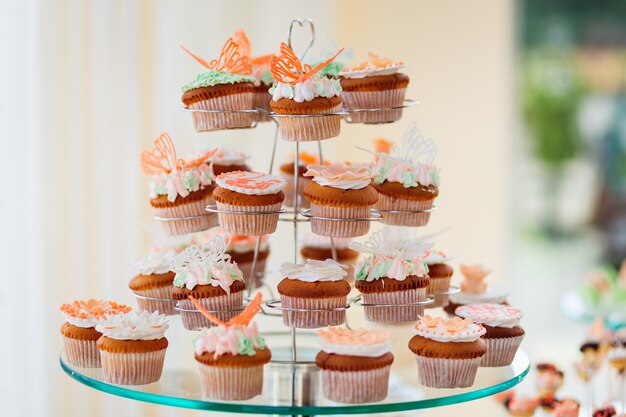 Cupcakes with white cream and orange glaze