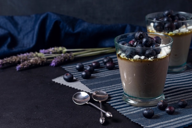 Cups of chocolate mousse with blurred background