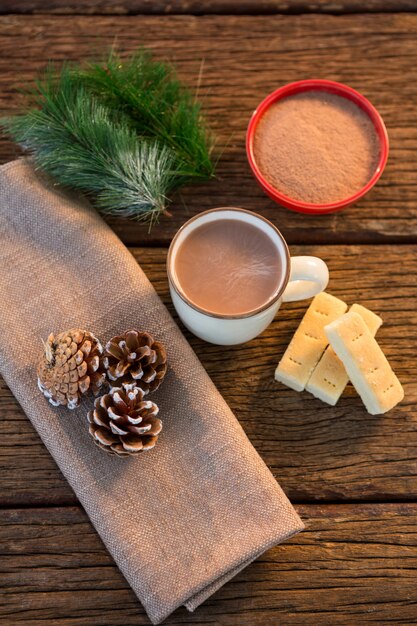 Free photo cups of coffee with nougat and pine cones