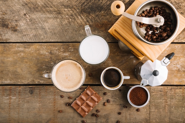 Cups with coffee near grinder