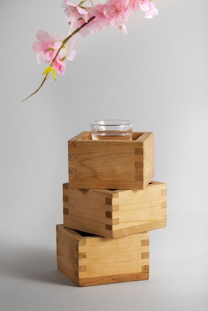 Cups with sake beverage and flowers