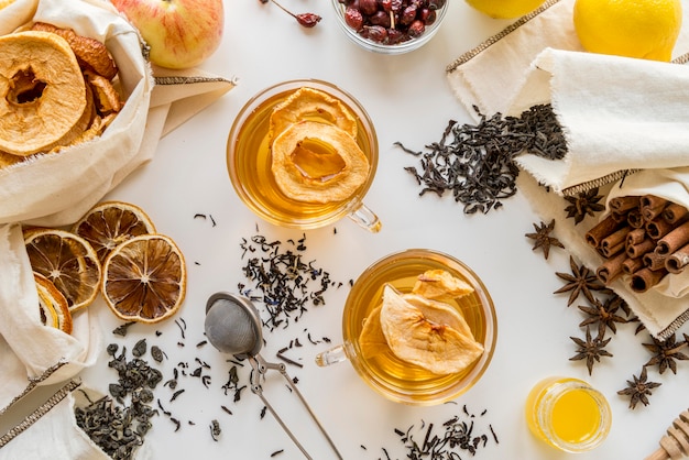 Cups with tea herbs and lemon
