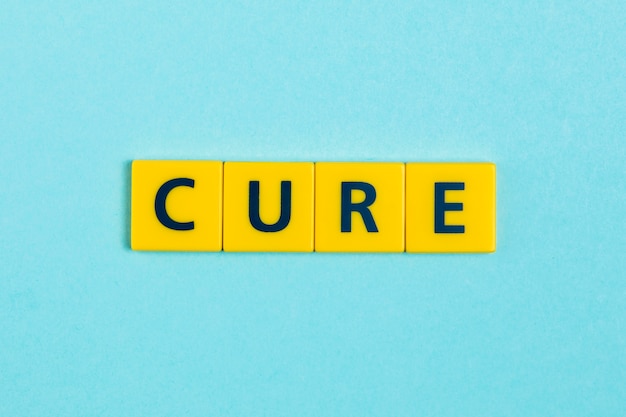 Cure word on scrabble tiles