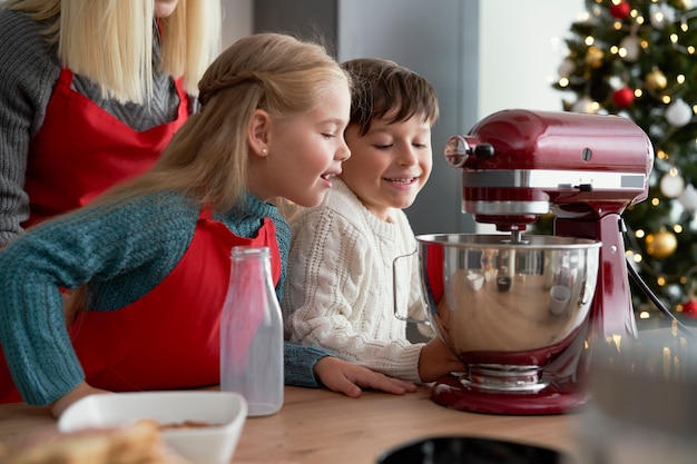 Free photo curious children looking into electric mixer