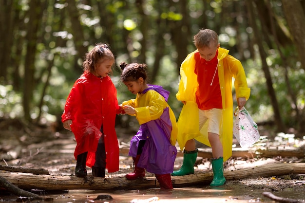 Free photo curious children participating in a treasure hunt in the forest