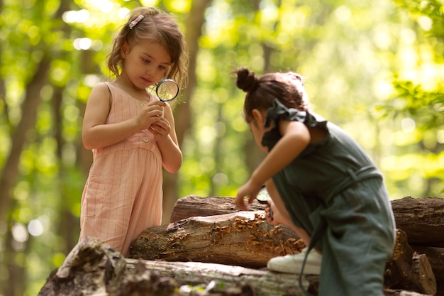 Free photo curious children participating in a treasure hunt