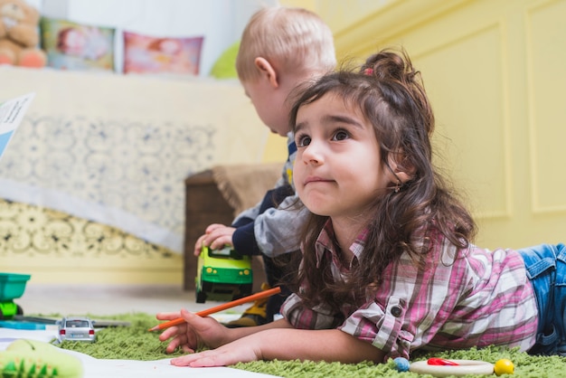 Curious girl with pencil watching