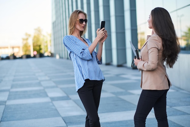 Curious journalist is taking interview from successful businesswoman on the street.