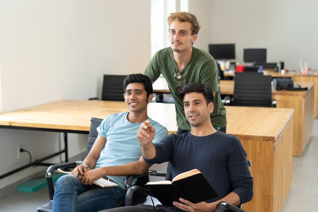 Curious students watching presentation and discussing it