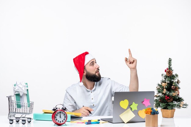 Curious young businessman in office celebrating new year or christmas working