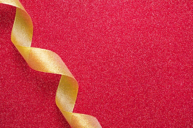 Free photo curling ribbon crossing red background