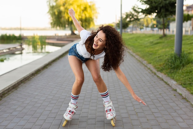 Curly girl taking a walk with her rollerblades
