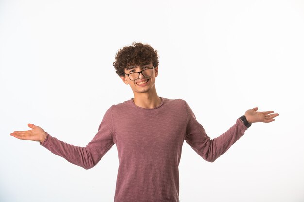 Curly hair boy in optique glasses looks self confident and successful.