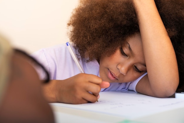 Curly-haired little girl doing homework