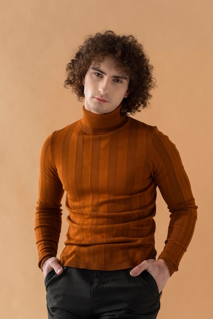 Free photo curly haired man with brown blouse posing