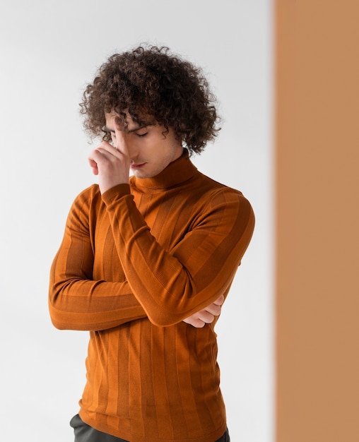 Free photo curly man with brown blouse posing