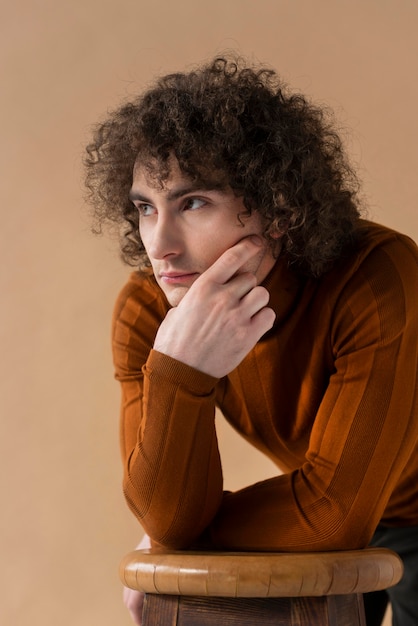 Free photo curly man with brown blouse posing