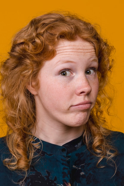 Free photo curly redhead young woman surprised