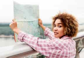 Free photo curly woman checking a map