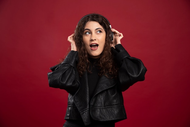 Curly woman listening to music.