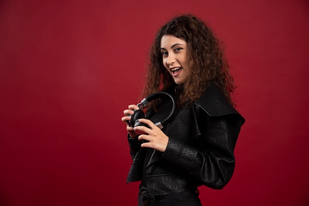 Curly woman posing with headphones.