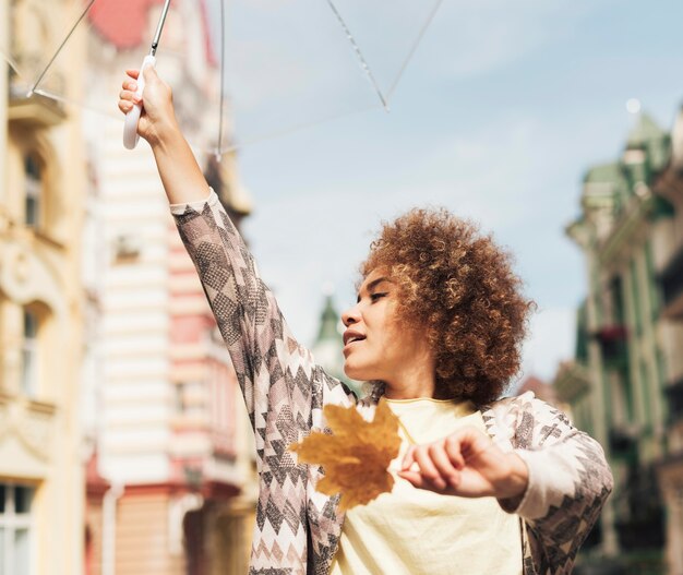 Curly woman posing with an umbrella