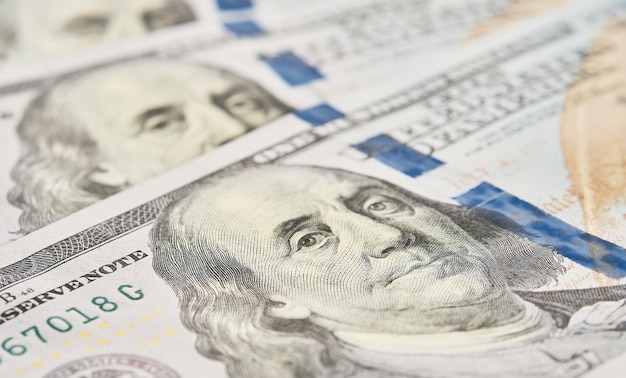 Currency closeup of one hundred US dollars banknotes Portrait of the president selective focus Business finance concept business news splash screen banner mockup