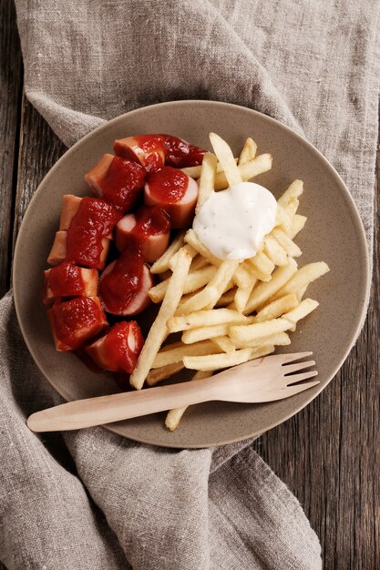 Curry wurst with sauce and french fries