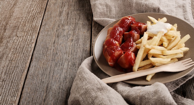 Curry wurst with sauce and french fries