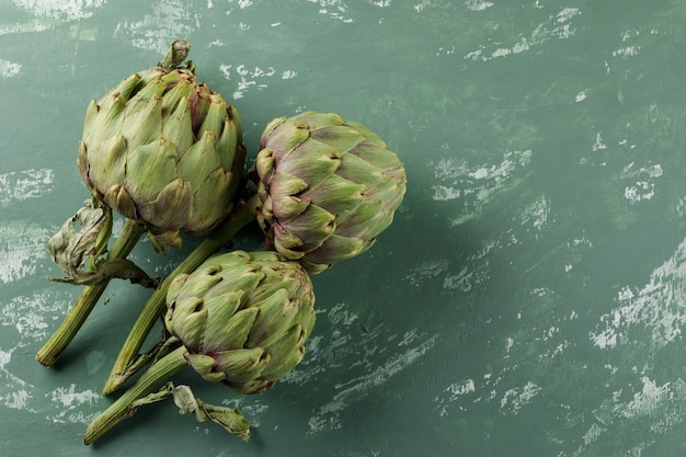 Custard apples on a greenish plaster table. flat lay.