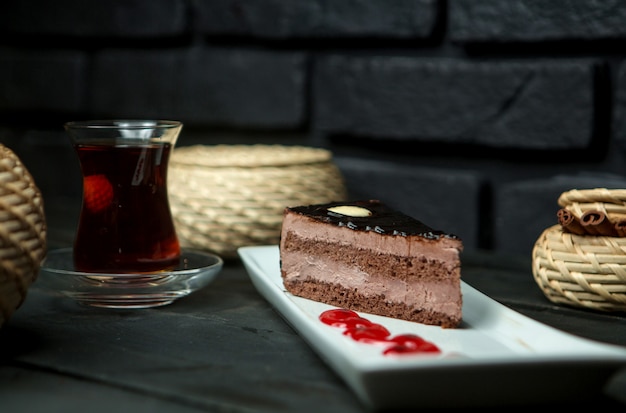 Custard chocolate sponge cake and cup of hot tea