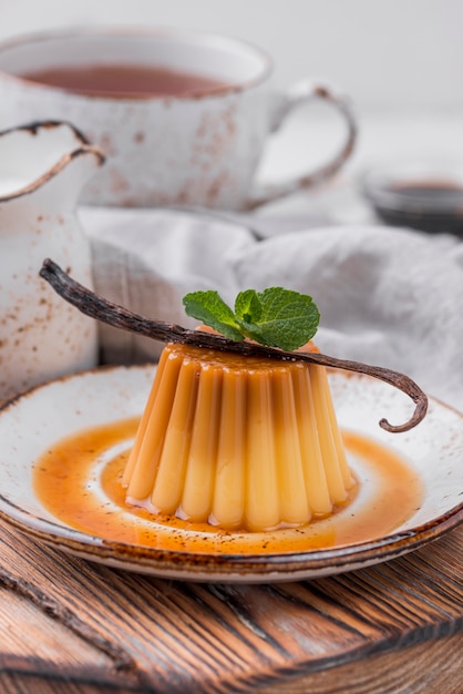 Custard on plate with mint and vanilla pod