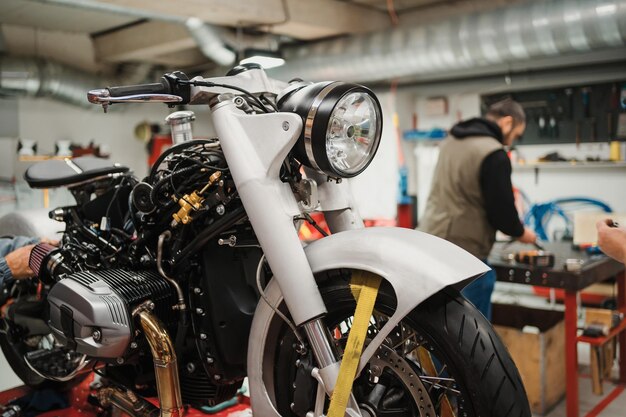 Custom motorcycle standing in repair shop