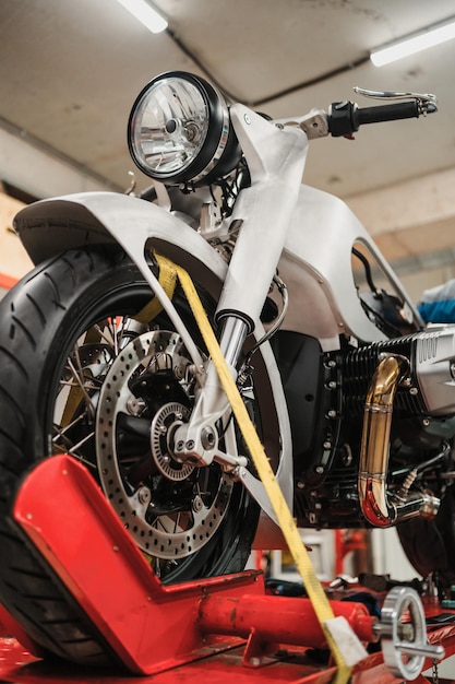 Custom motorcycle standing in repair shop